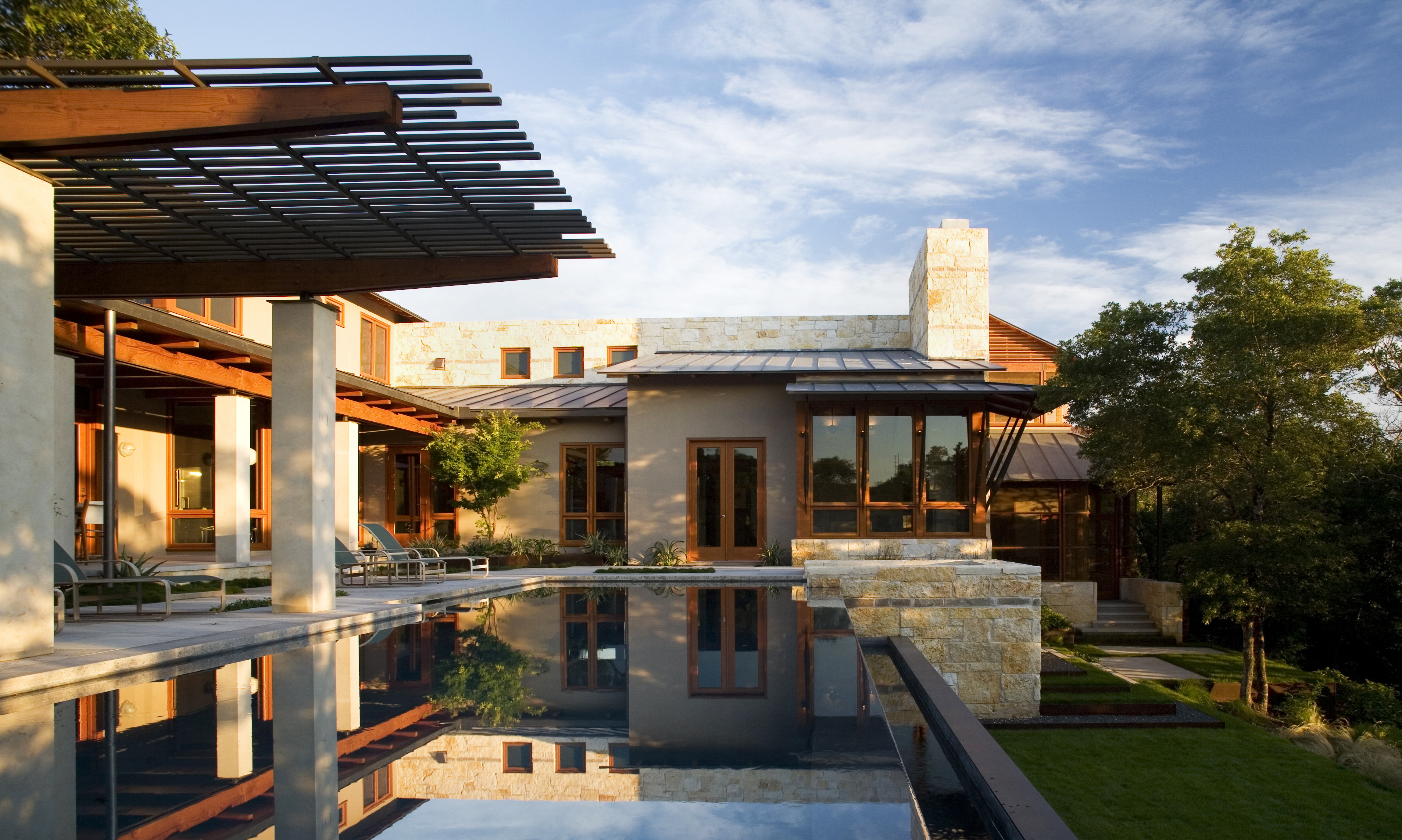Residential Engineering of a house in Austin with a large infinity pool and stone siding.